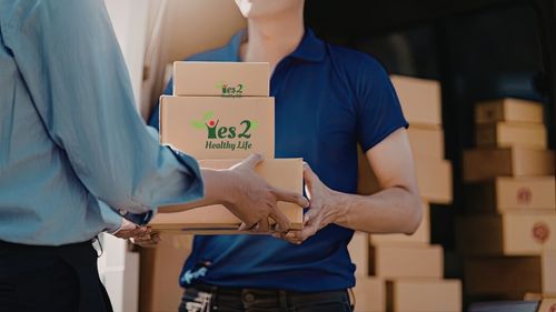 Courier delivering a branded healthy snack box to a customer islandwide